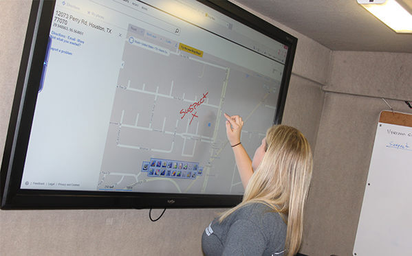 person drawing on the interactive display during meeting