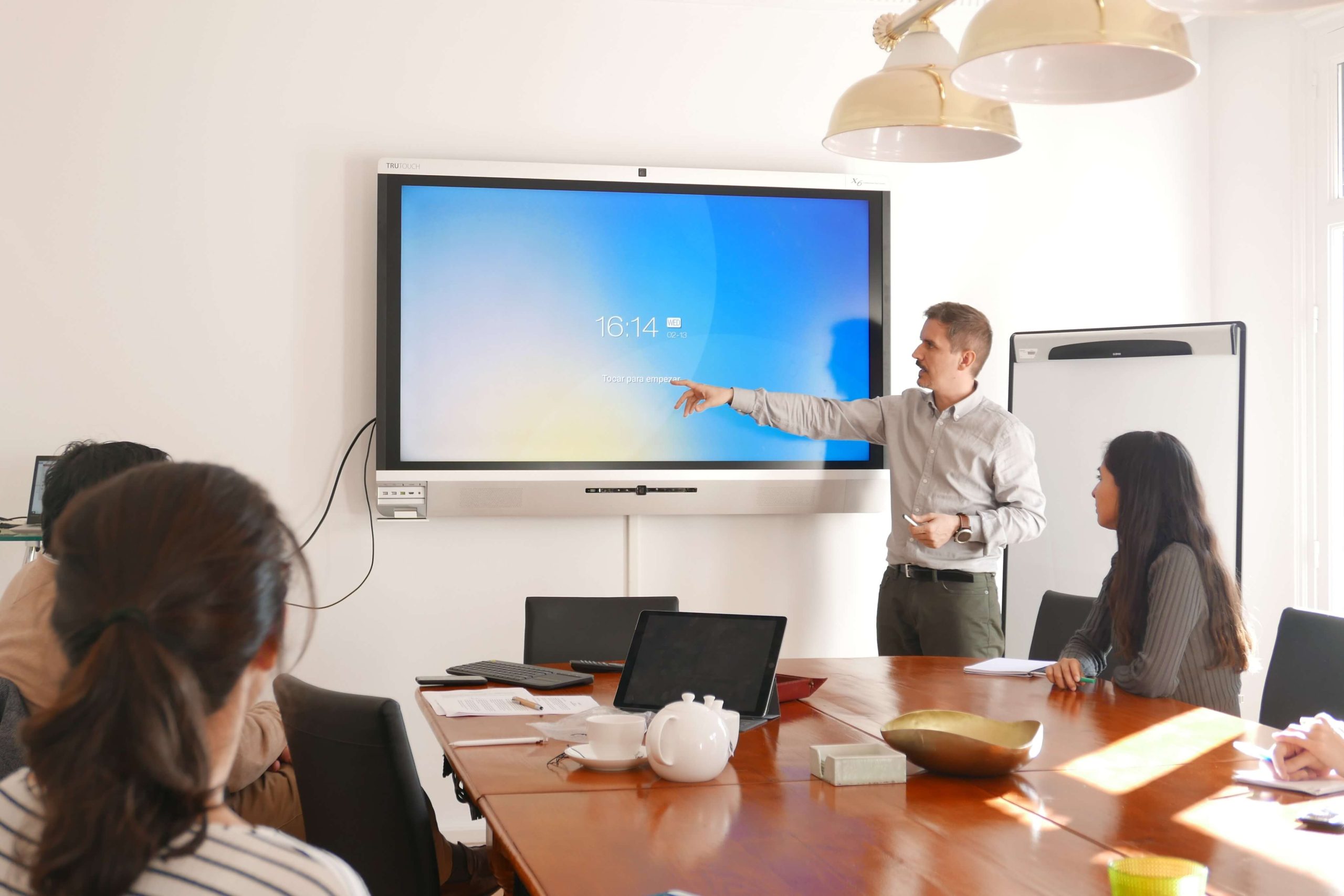 person speaking in meeting on interactive display