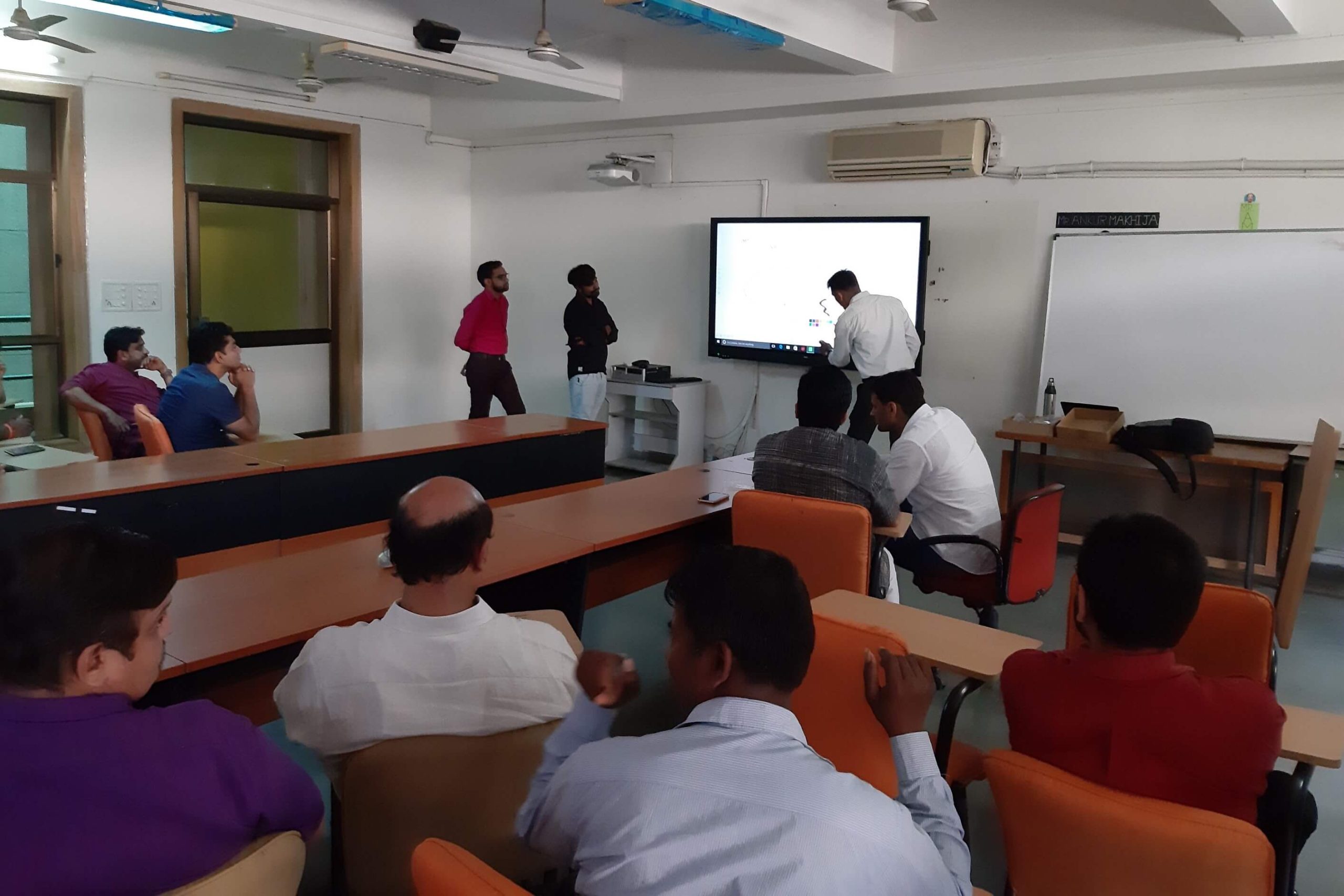person speaking in meeting on interactive display