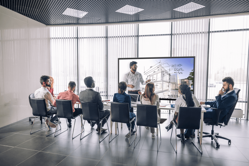 person speaking in meeting on interactive display