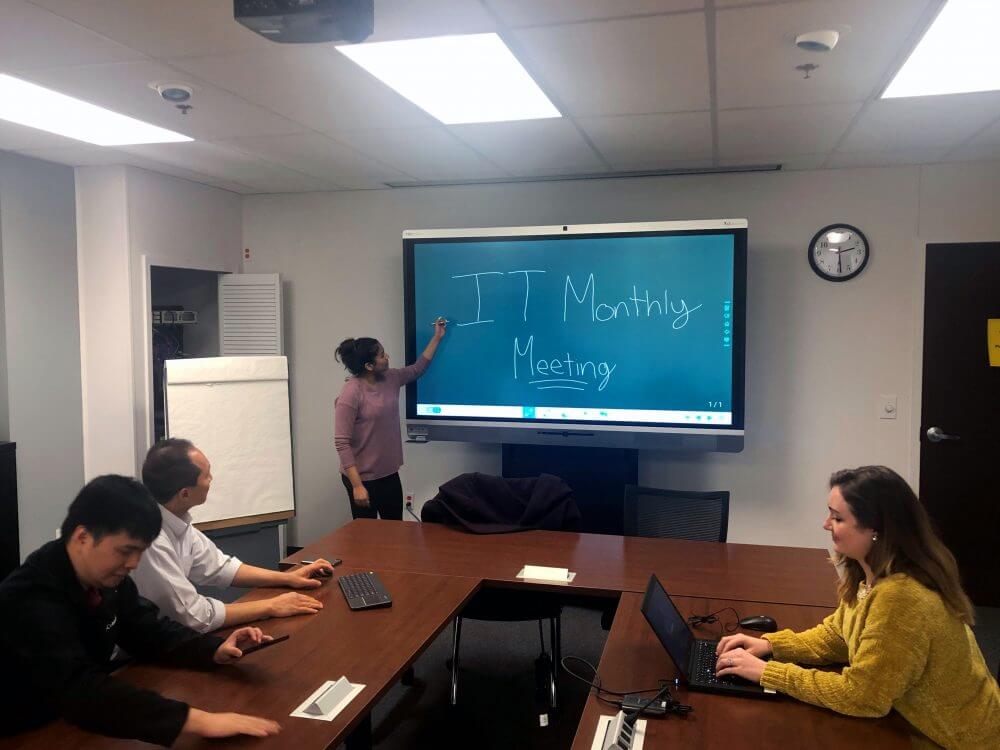 person speaking in meeting on interactive display